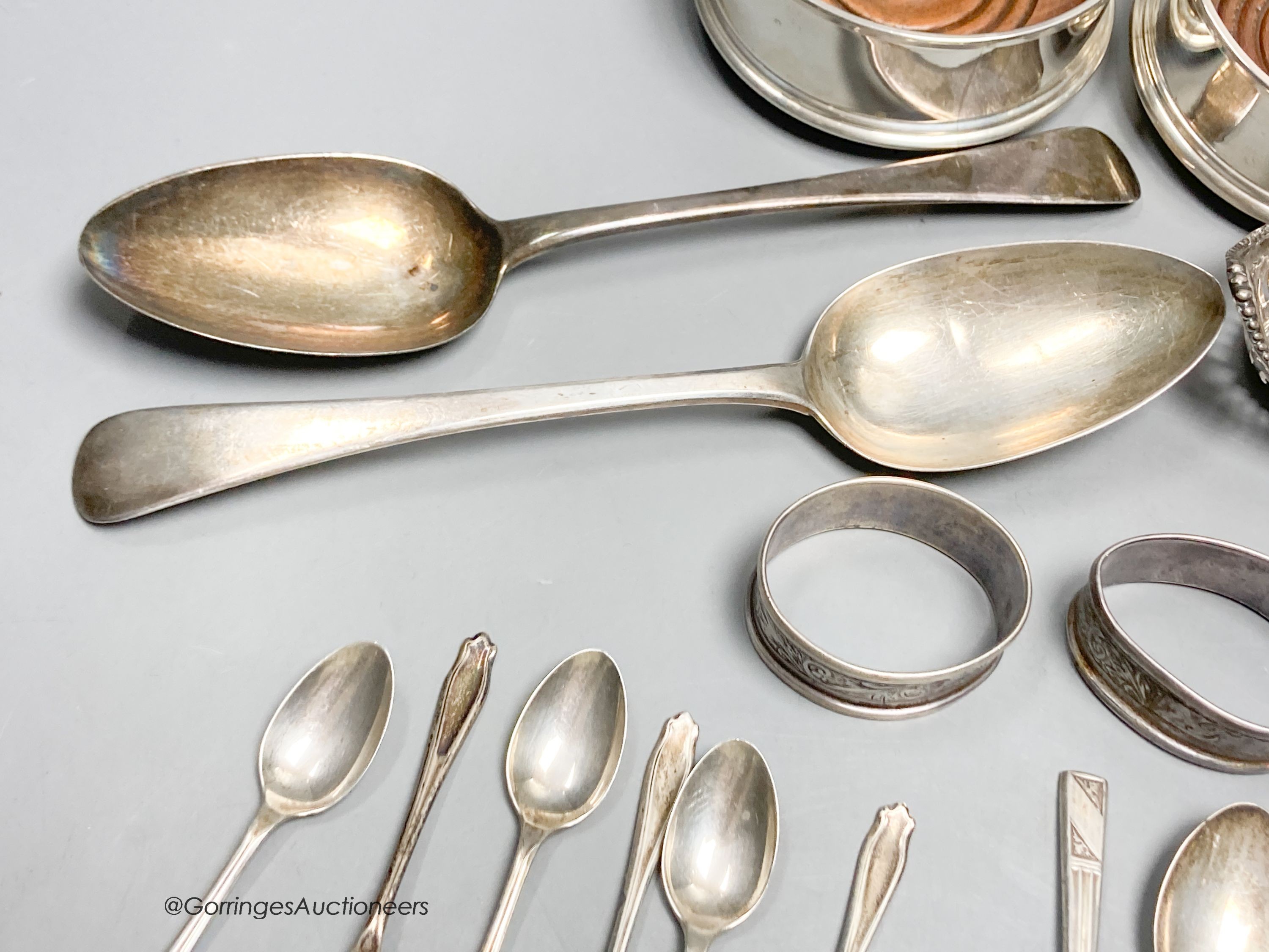 A pair of George III silver tablespoons, a pair of modern silver bottle coasters, a pair of pierced silver bon bon dishes, six silver teaspoons and 6 silver coffee spoons.